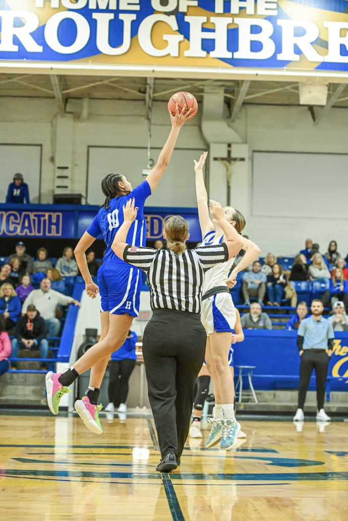 Marissa Green (12) tips off the ball in favor of Highlands. 